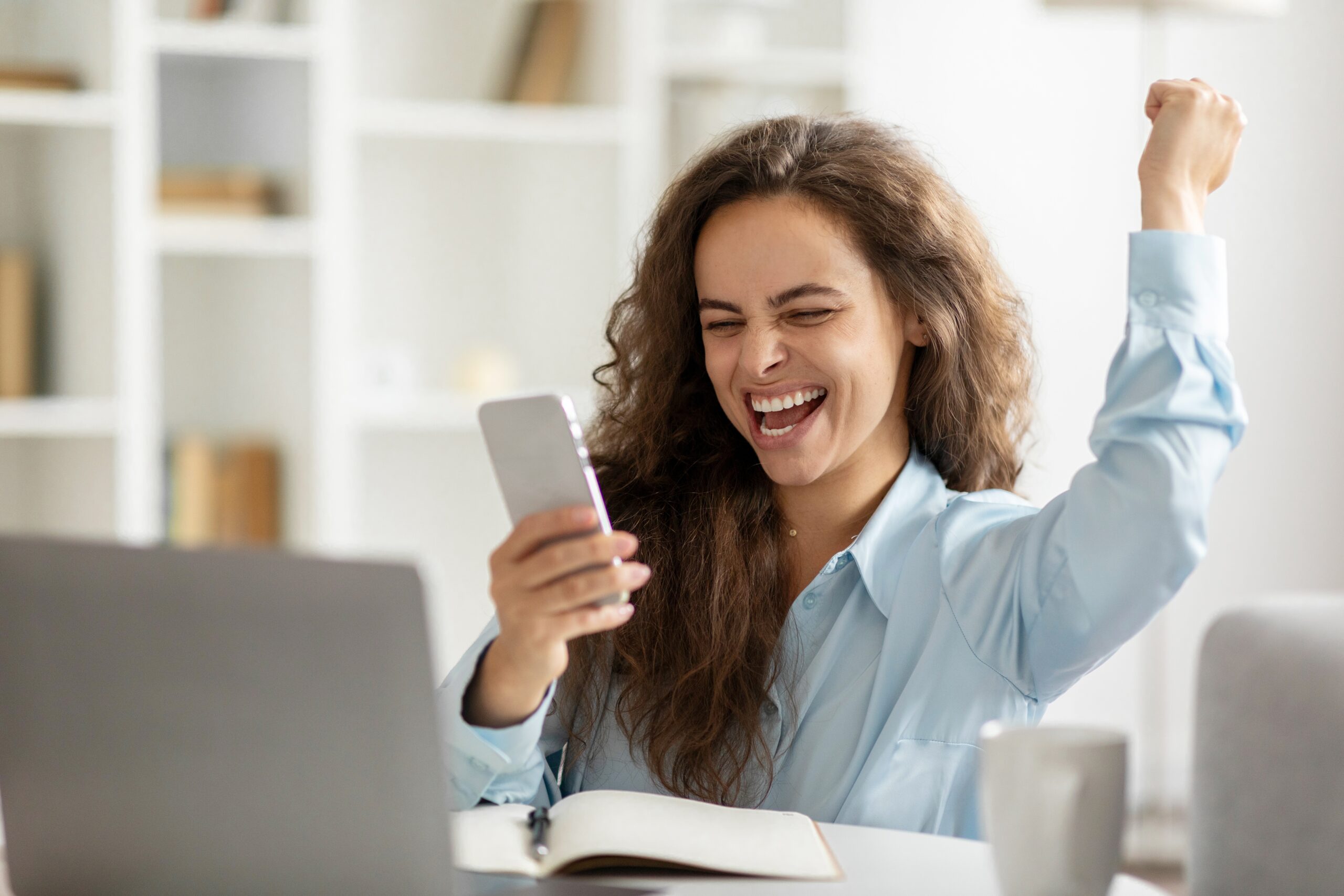 A happy young woman hired for a sales job.