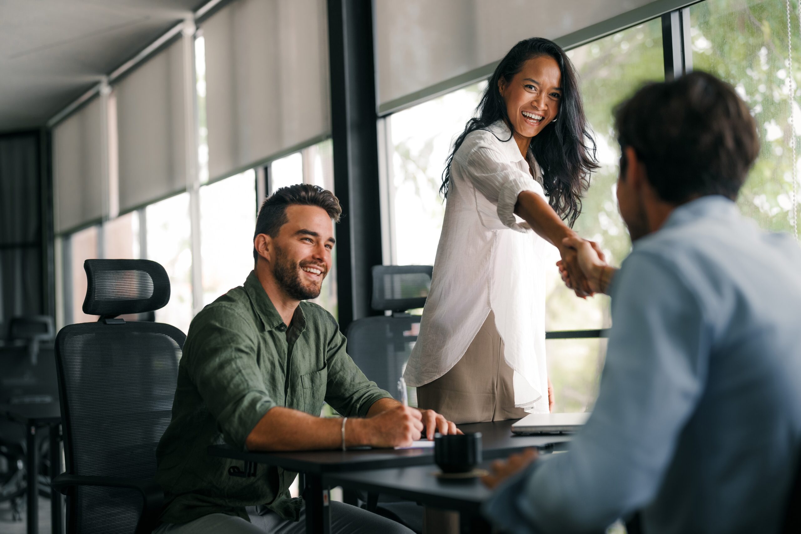 A direct sales rep shaking hands with customers.